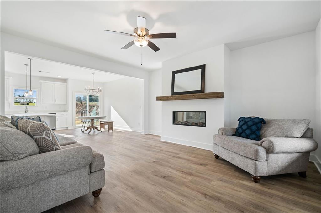 518 Old Canton Road Ball Ground, GA 30107 - Photo 6 of 42 a living room with furniture and a wooden floor