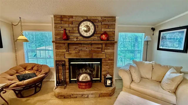a living room with furniture a clock and a fireplace