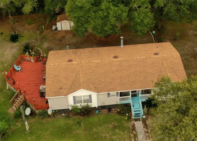 an aerial view of a house with a yard