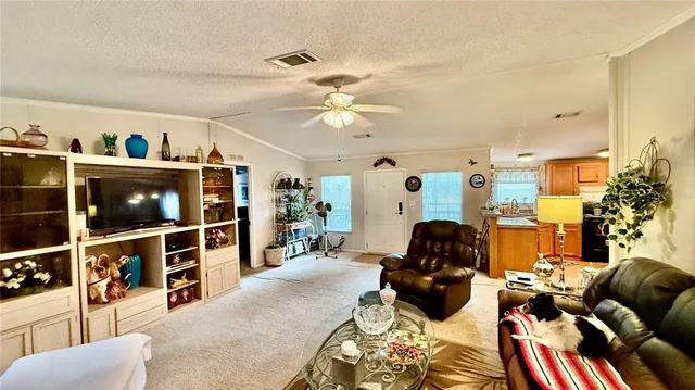 a living room with furniture and floor to ceiling window
