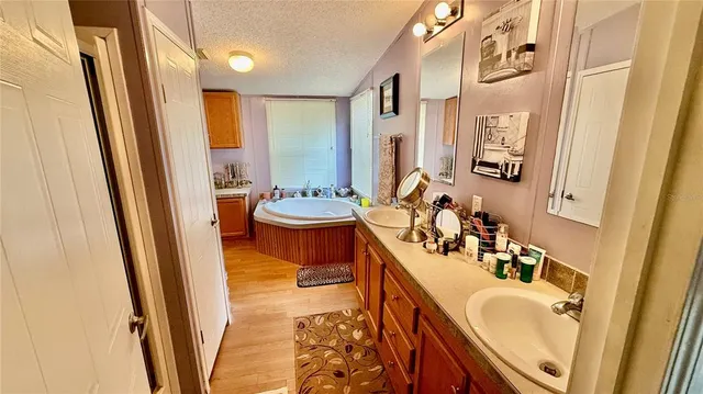 a bathroom with a granite countertop sink and a bathtub