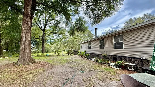 a view of a chair and table in the backyard