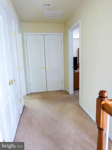 a view of a workspace with furniture and a potted plant