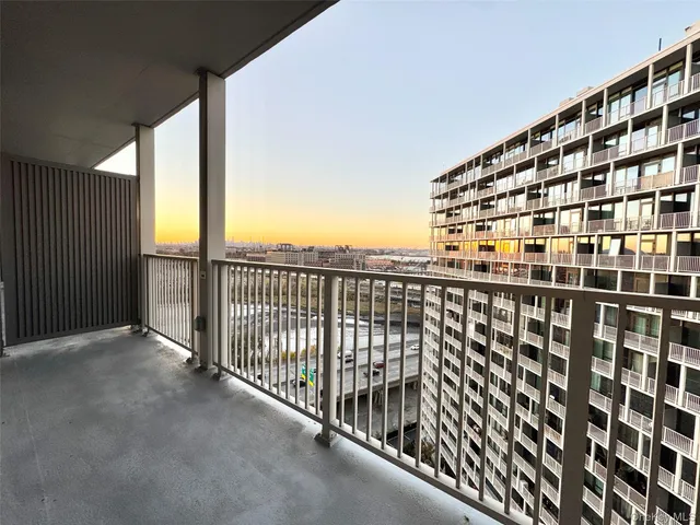 a view of balcony with a floor to ceiling window and wooden fence
