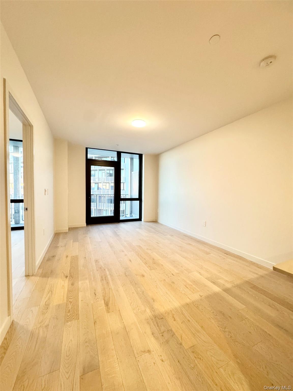 131-02 B 40th Road, Unit 16M Queens, NY 11354 - Photo 9 of 17 a view of an empty room with a window