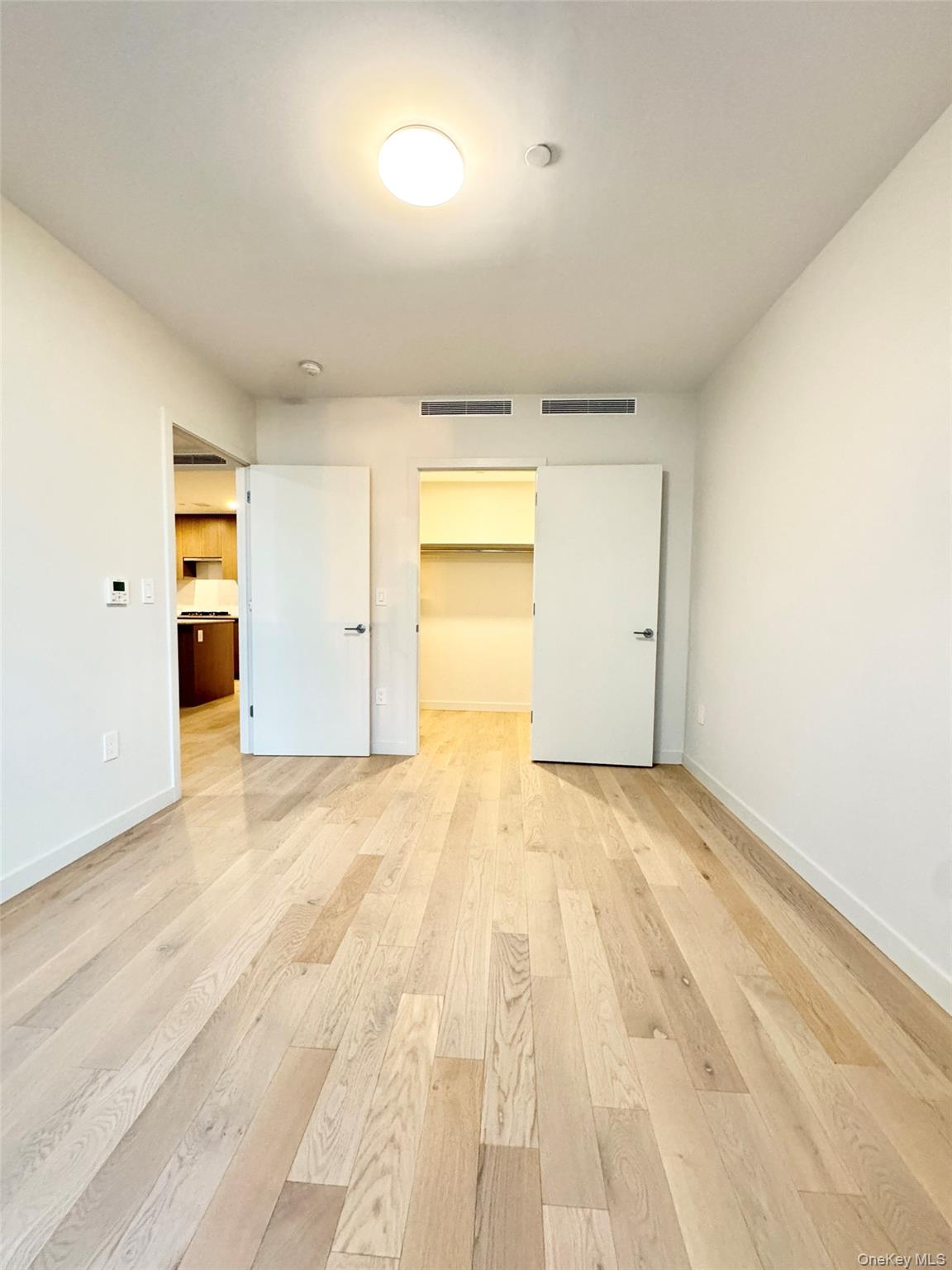 131-02 B 40th Road, Unit 16M Queens, NY 11354 - Photo 10 of 17 an empty room with a natural light