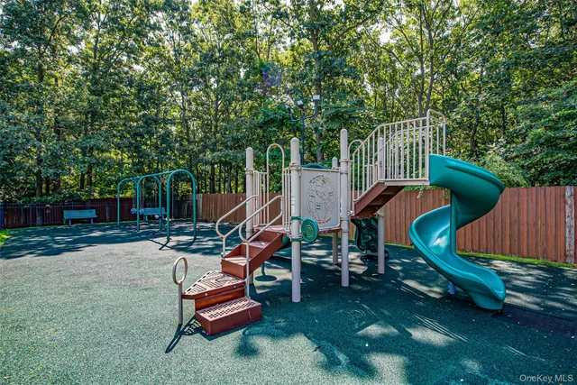 a wooden bench sitting in the middle of a yard