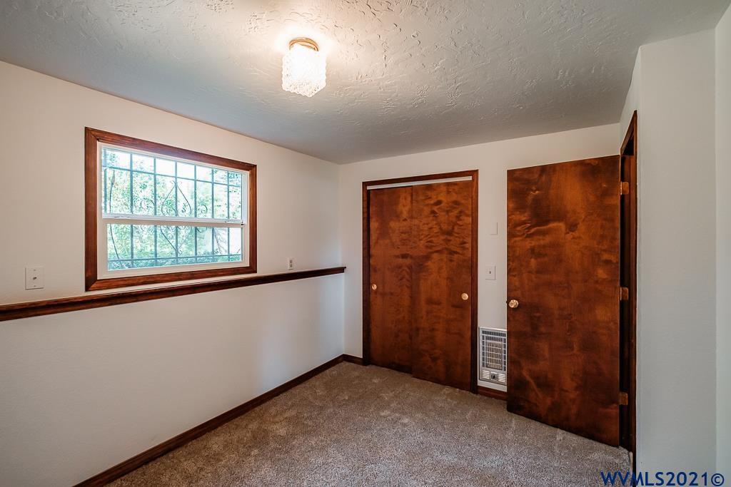 1278 Southwest Maple Street Dallas, OR 97338 - Photo 24 of 42 an empty room with windows closet and chandelier fan