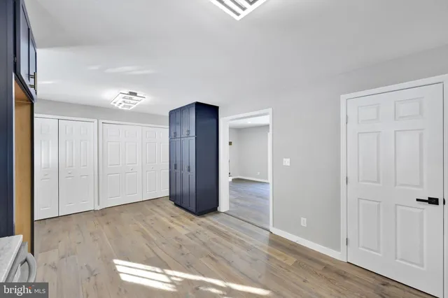 a view of empty room with wooden floor and fireplace