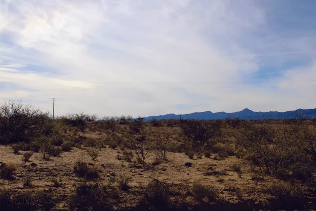a view of a large mountain with mountains in the background