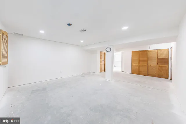 a spacious bathroom with a double vanity sink a mirror and a toilet