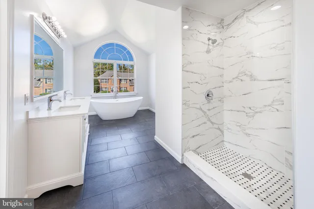 a kitchen with stainless steel appliances granite countertop a sink and a refrigerator
