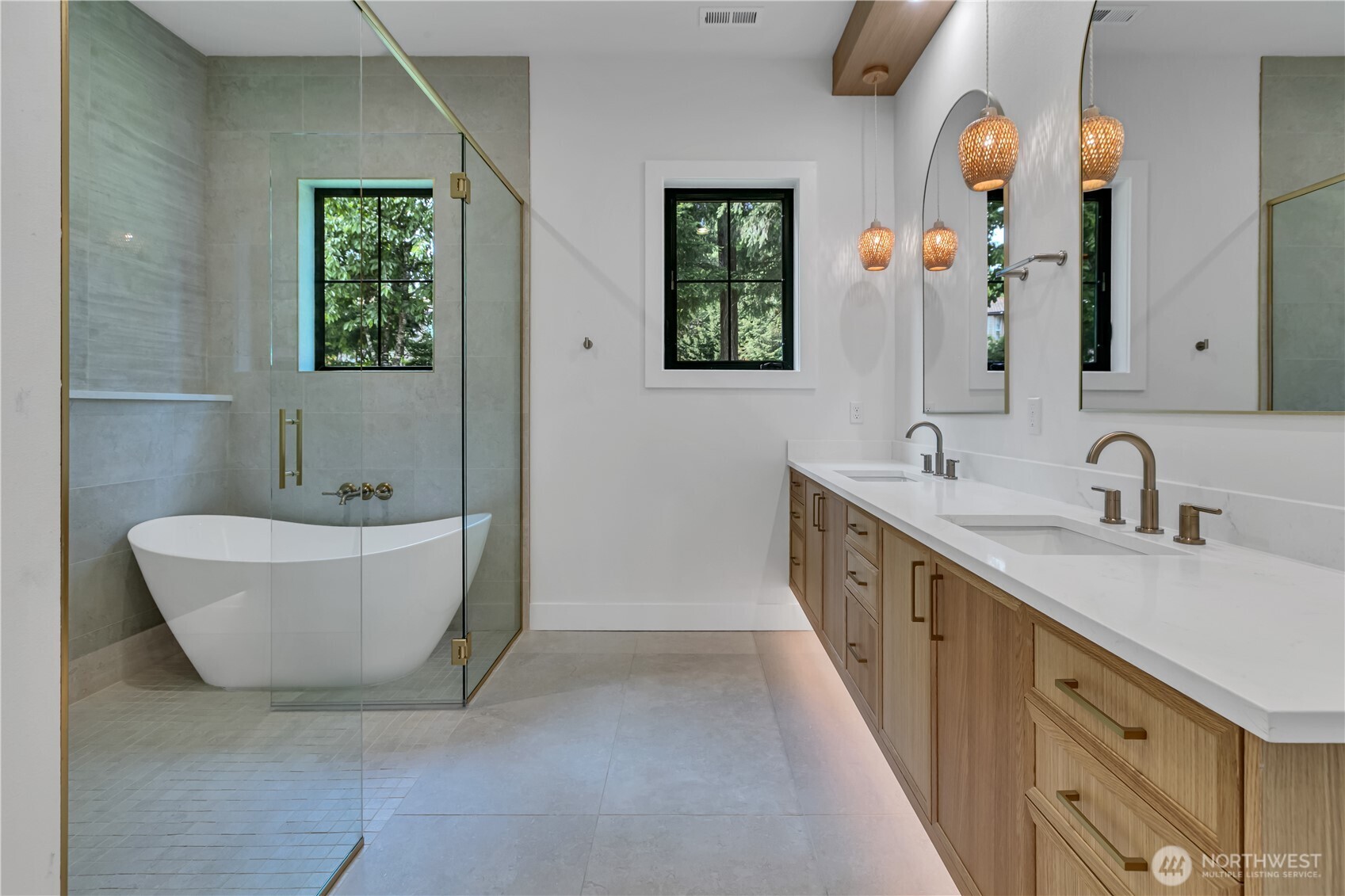 6709 254th Street East Graham, WA 98338 - Photo 21 of 40 a bathroom with a double vanity sink a mirror and a bathtub