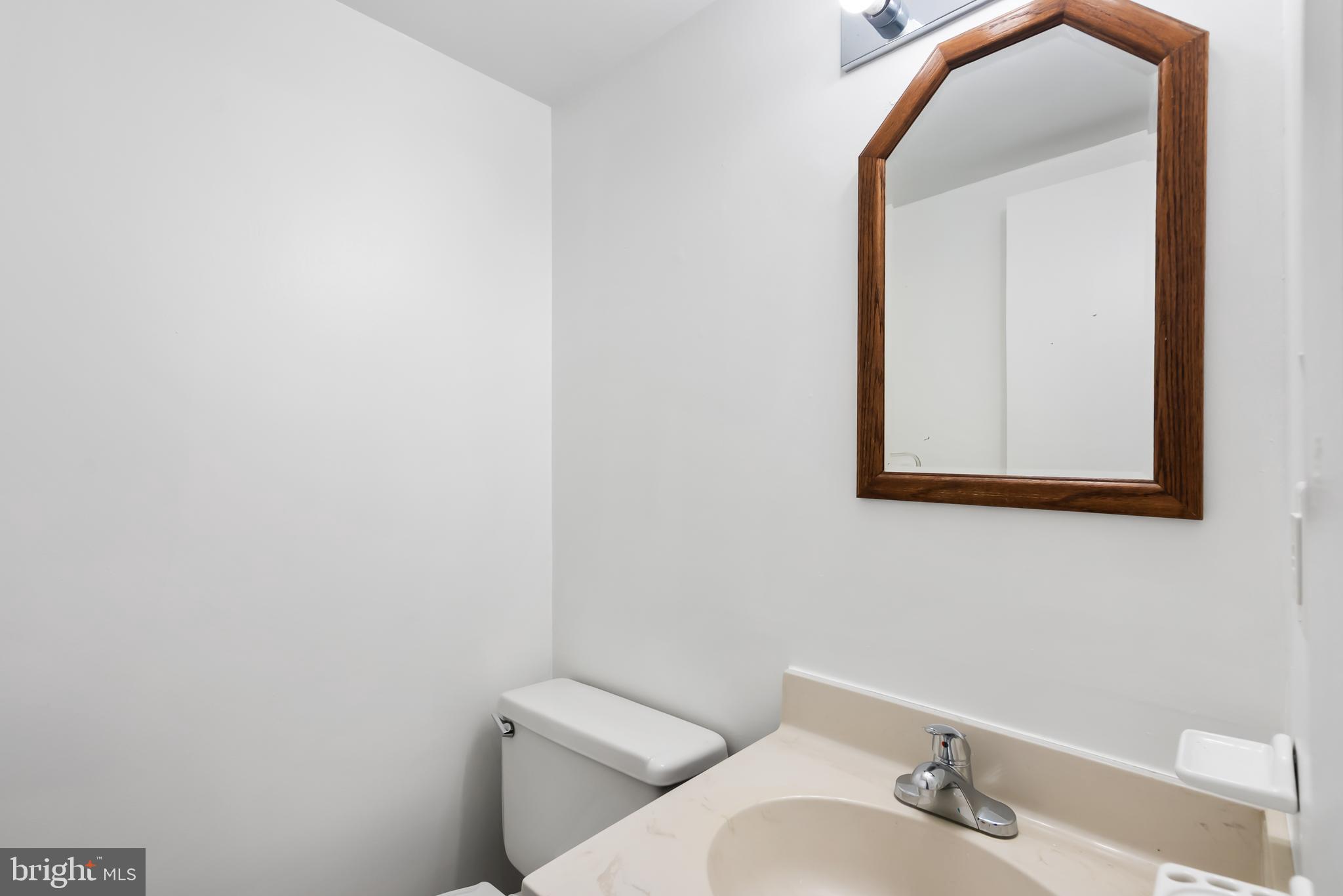 1851 Sharwood Place Crofton, MD 21114 - Photo 18 of 27 a bathroom with a toilet sink and mirror