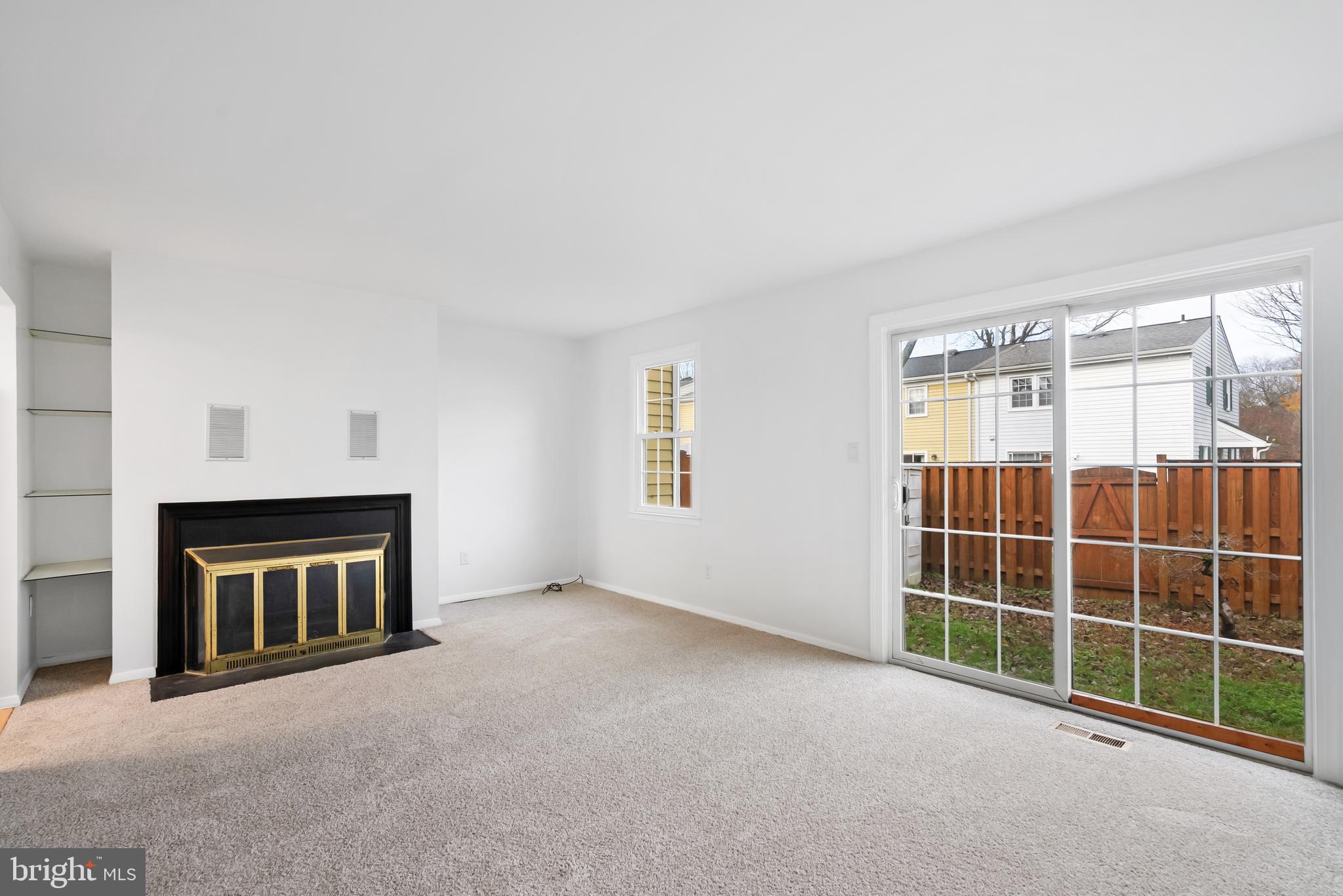 1851 Sharwood Place Crofton, MD 21114 - Photo 4 of 27 a view of an empty room with a fireplace and windows