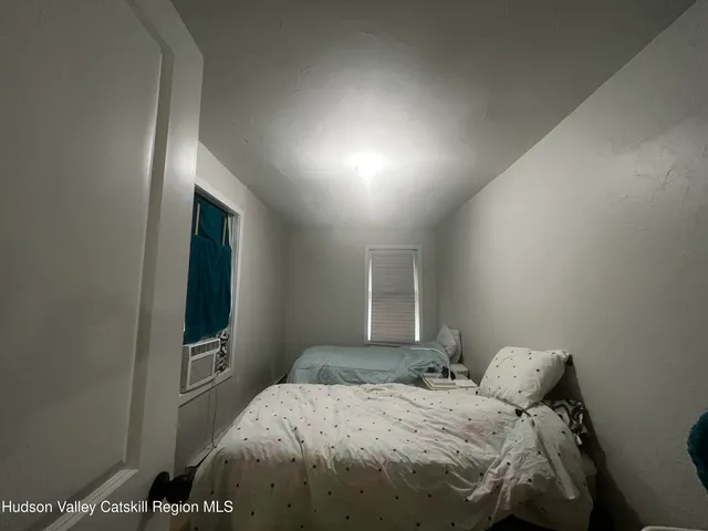 a bedroom with a bed and a tv