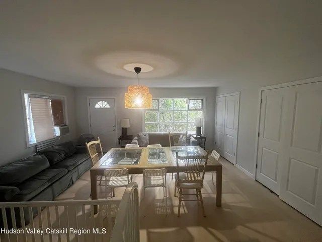 a view of a dining room with furniture and window