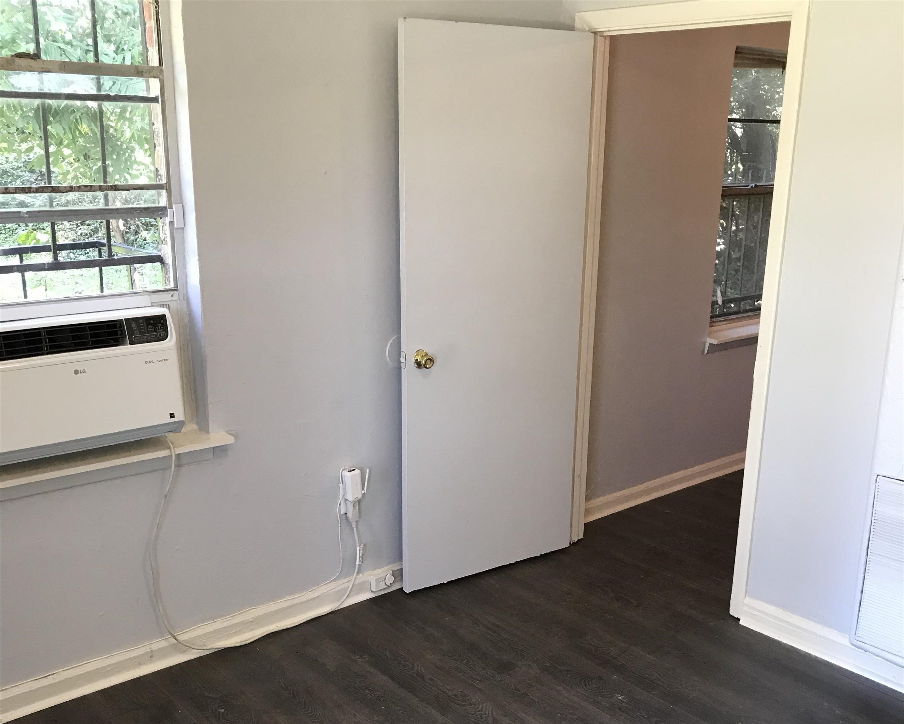 1463 Effie Road Memphis, TN 38106 - Photo 3 of 3 an empty room with wooden floor and windows