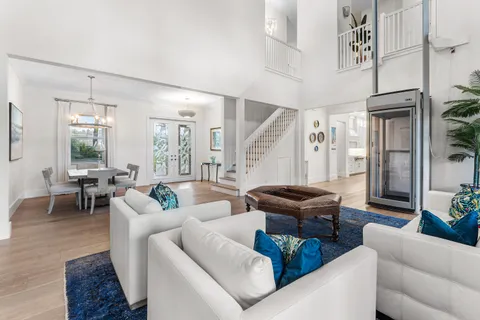 a kitchen with stainless steel appliances kitchen island granite countertop a wooden floor and cabinets