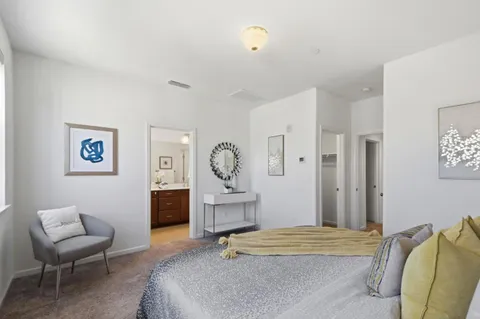 a bedroom with a bed and a chair