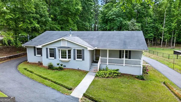 a front view of house with yard and green space