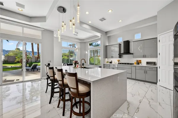 a large kitchen with stainless steel appliances lots of counter top space