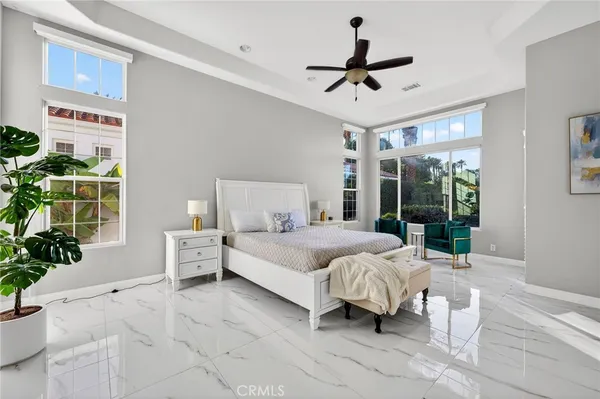 a living room with patio furniture and a large window