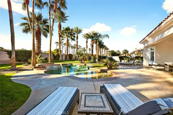 a view of outdoor space with seating area and swimming pool
