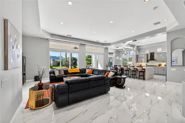 a kitchen with kitchen island a dining table and chairs