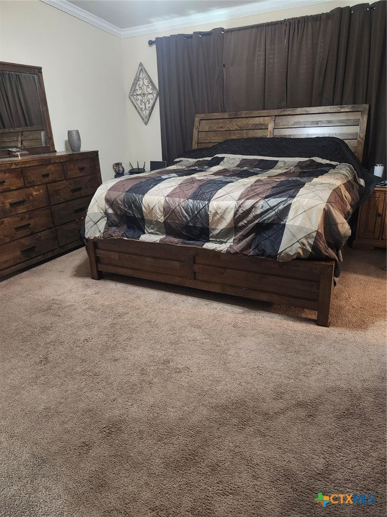 1845 Royal Road Port Lavaca, TX 77979 - Photo 11 of 22 a bedroom with a bed and wooden floor