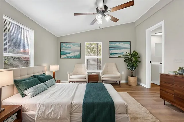 a bedroom with a large bed and a chandelier