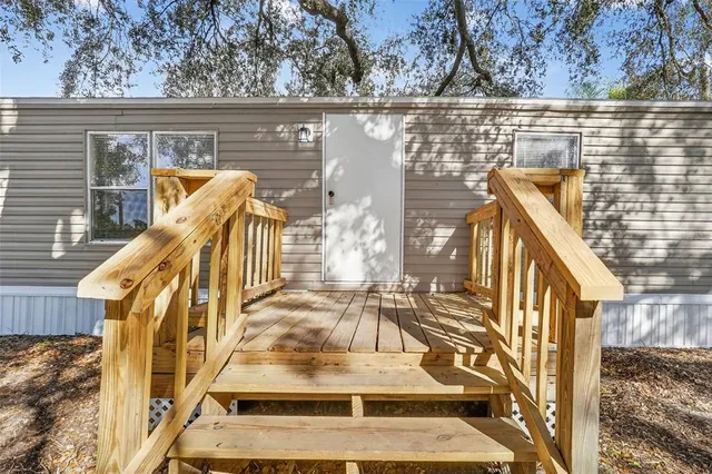 a view of a balcony with wooden floor and fence