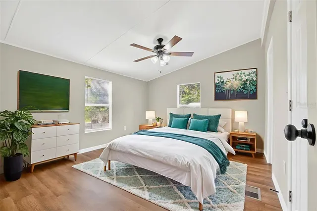 a bedroom with a bed and a flat screen tv