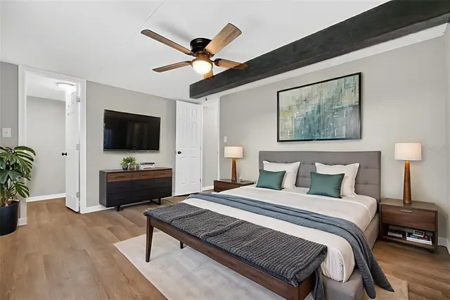 a bedroom with a bed and a flat screen tv