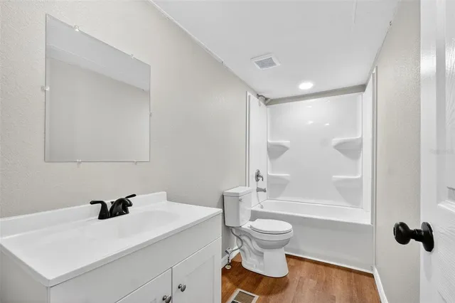 a bathroom with a sink toilet a mirror and shower