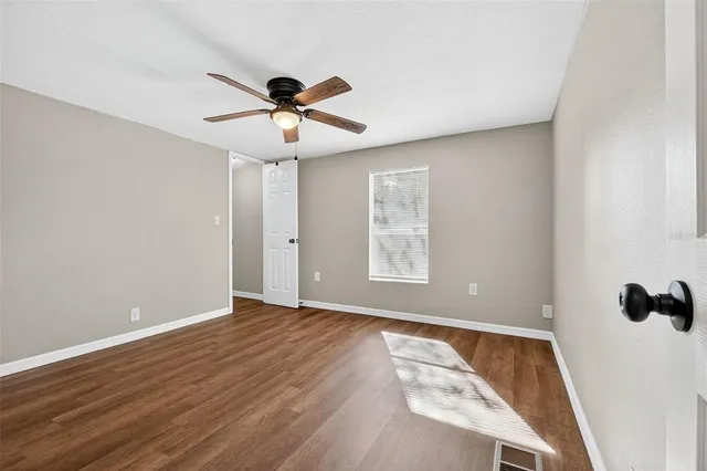wooden floor in an empty room with a window