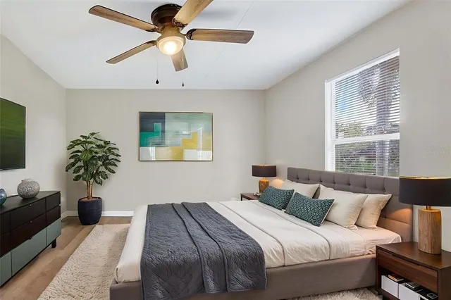 a bedroom with a bed and a potted plant