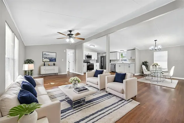 a living room with furniture and a chandelier