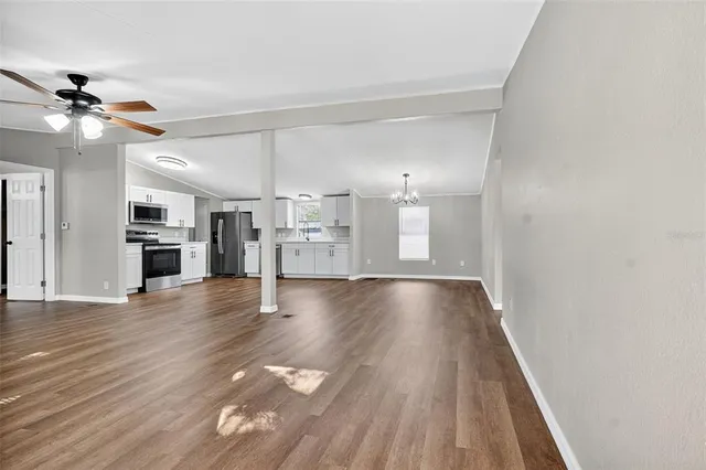 a view of a kitchen with wooden floor and a kitchen