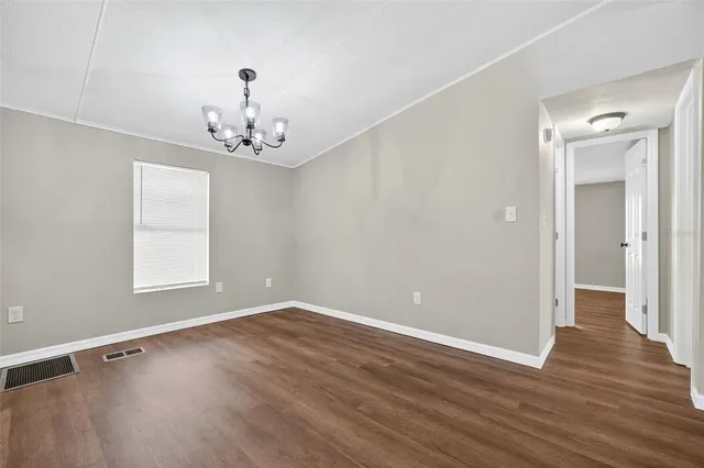 a view of a room with wooden floor and window