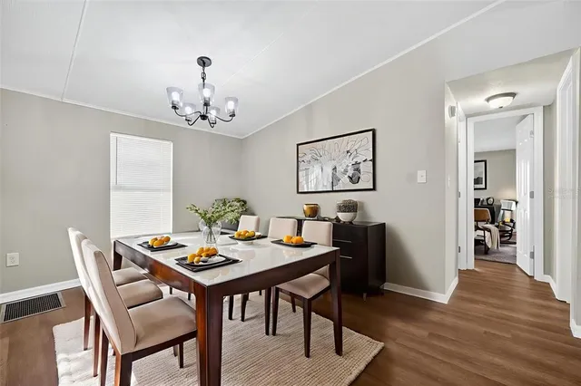 a view of a dining room with furniture wooden floor and a chandelier