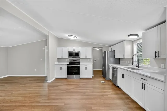 a large kitchen with a stove top oven and refrigerator