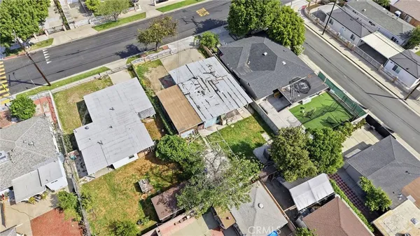 an aerial view of multiple houses with yard