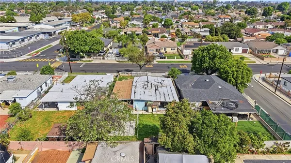 an aerial view of multiple houses with yard
