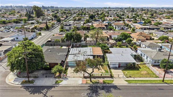 an aerial view of residential houses with yard