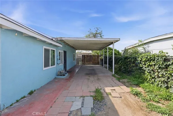 a view of a patio with table and chairs and potted plants