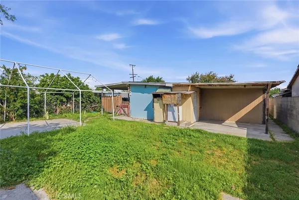 a view of a house with a backyard and a garden