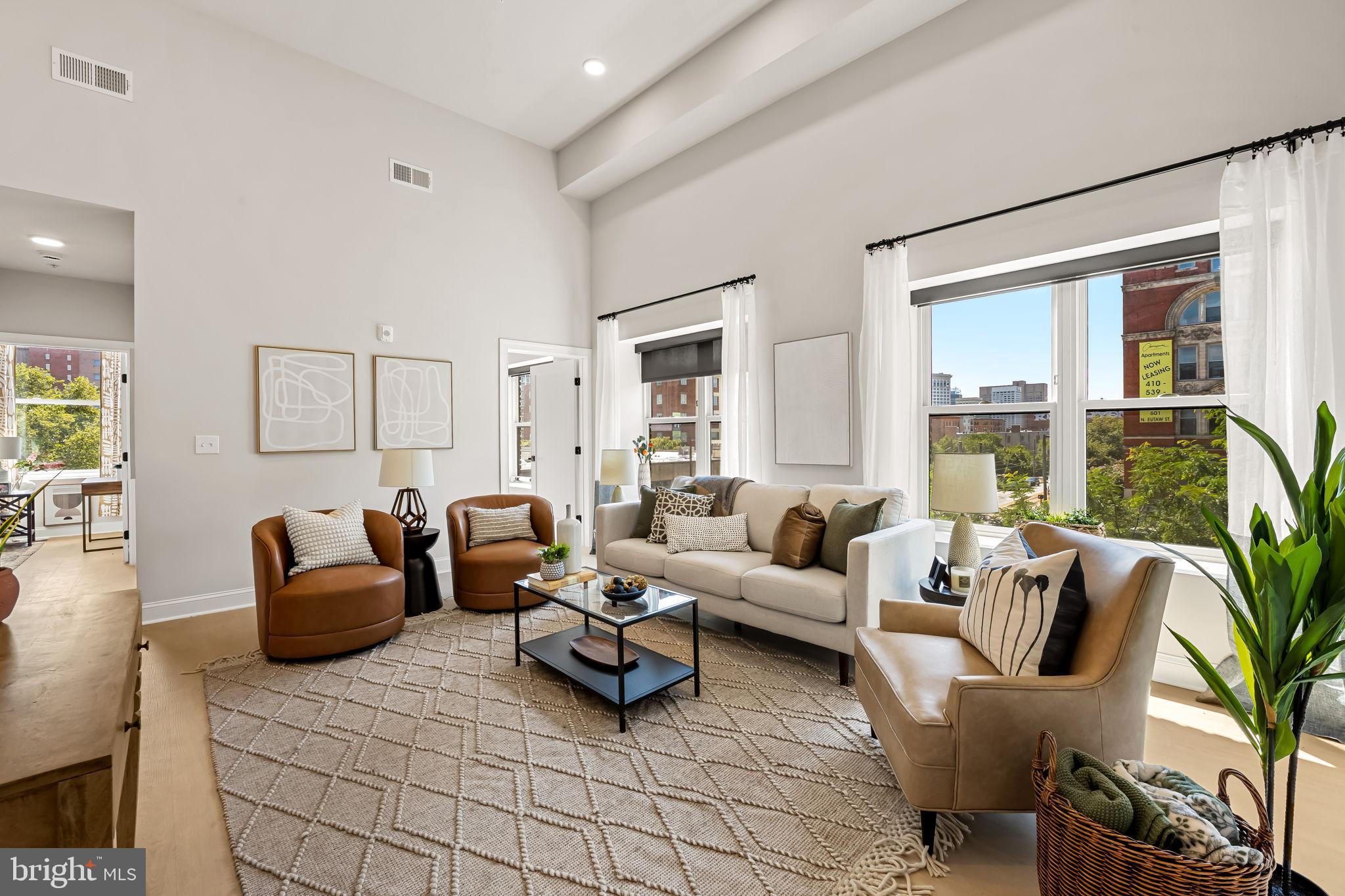 a living room with furniture and a large window