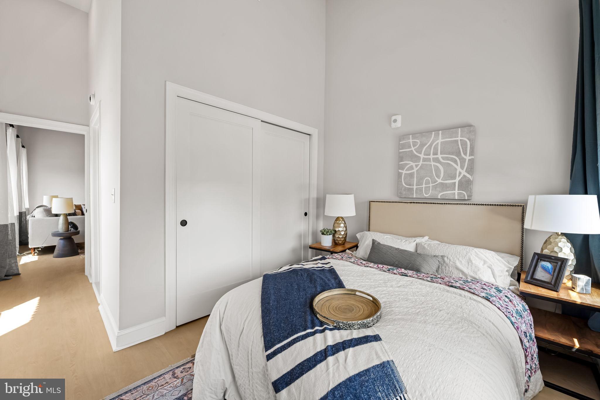 600 North Howard Street, Unit 101 Baltimore, MD 21201 - Photo 15 of 20 a bedroom with bed and wooden floor