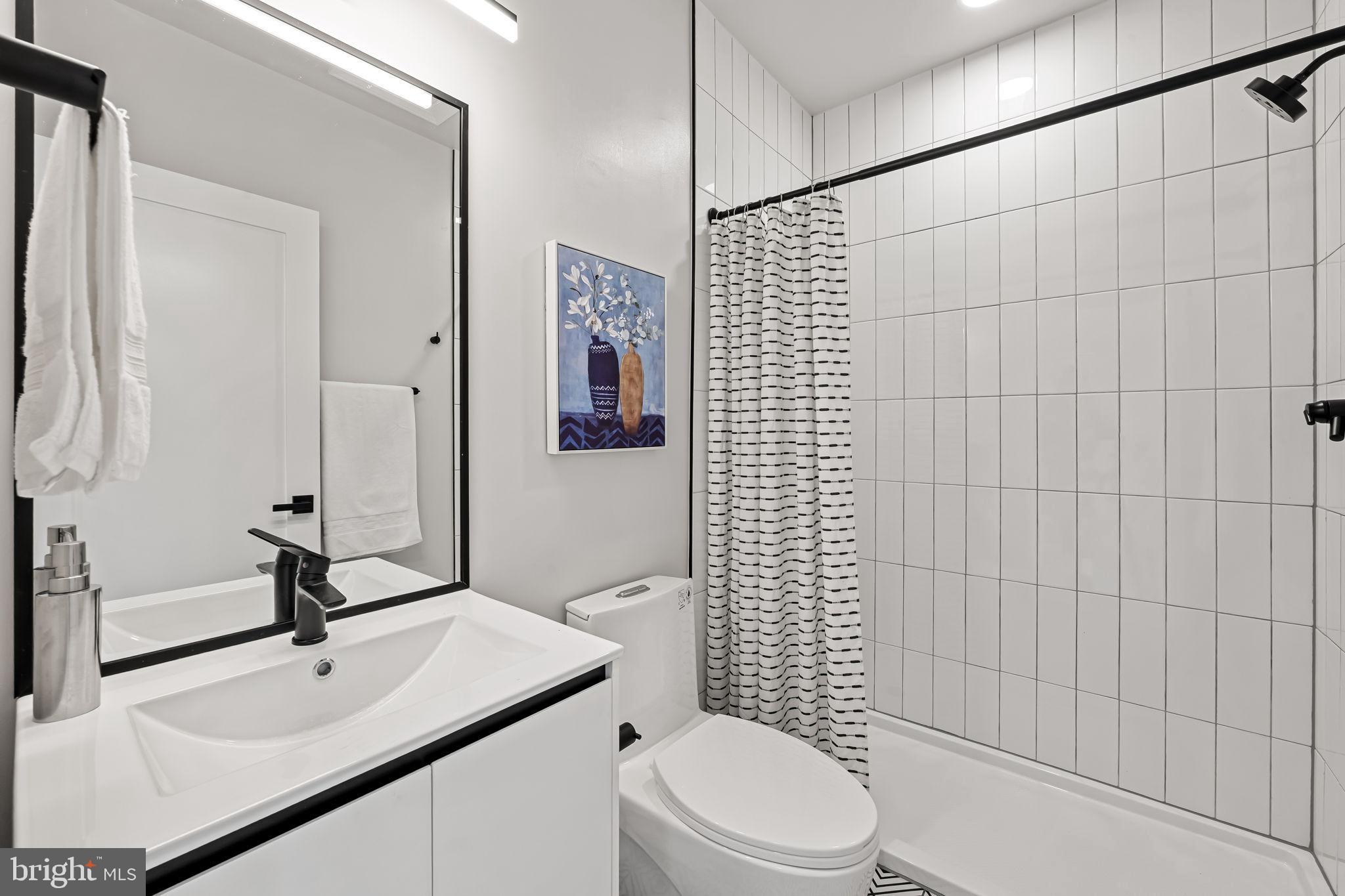 600 North Howard Street, Unit 101 Baltimore, MD 21201 - Photo 18 of 36 a bathroom with a sink a toilet and shower